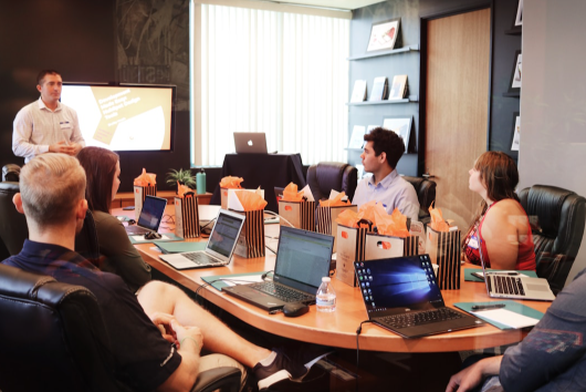 Team members in an office conference room, discussing the efficiency boost that AI deployment platforms can bring to business operations